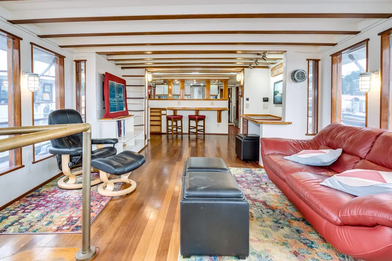 Slide: The Image of Interior of 1941 Custom Sagstad Fantail boat with modern furnishings and wooden flooring. - 4