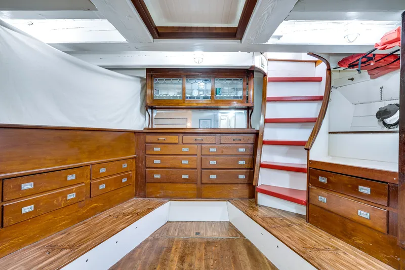 Slide: The Image of Interior of 1941 Custom Sagstad Fantail boat with wooden cabinetry and red-accented stairs. - 43
