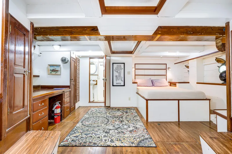 Slide: The Image of 1941 Custom Sagstad Fantail interior with wooden beams, bed, desk, and decorative rug. - 47