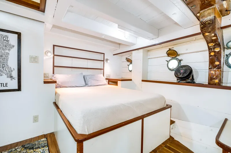 Slide: The Image of Cozy bedroom in 1941 Custom Sagstad Fantail boat with nautical decor and porthole windows. - 48