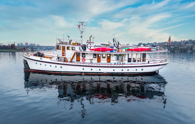 Slide: The Image of 1941 Custom Sagstad Fantail boat on calm water under a blue sky. - 5