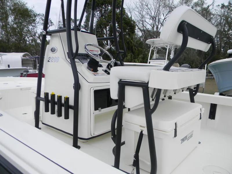 Slide: The Image of 2025 Pathfinder 2200 TRS boat interior with seating and console. - 2