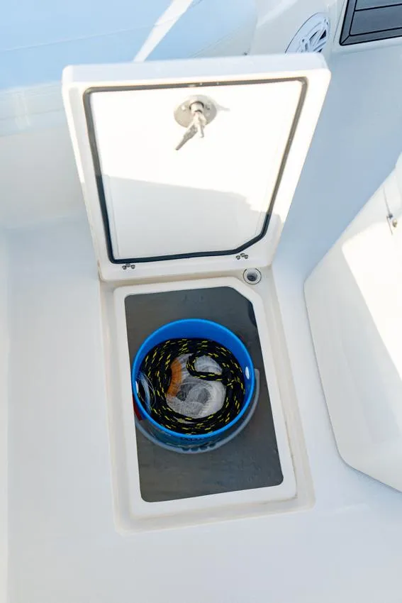Slide: The Image of Pathfinder 2200 TRS 2025 boat storage compartment with blue bucket inside. - 6