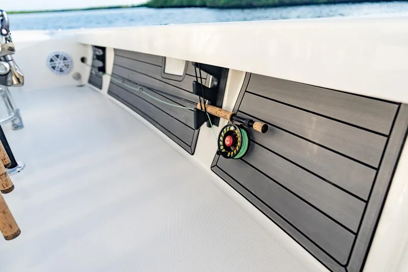 Slide: The Image of 2025 Pathfinder 2200 TRS boat interior with fishing rod storage. - 7