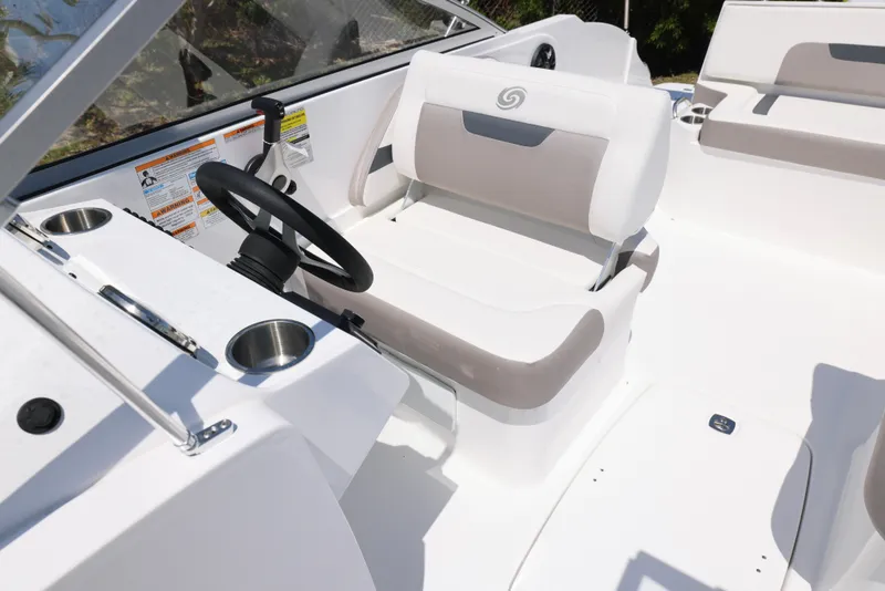 Slide: The Image of 2025 Hurricane SunDeck 235 OB boat interior with steering wheel and seating. - 17