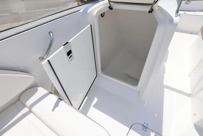 Slide: The Image of 2025 Hurricane SunDeck 235 OB boat storage compartment with open hatch, white interior. - 18