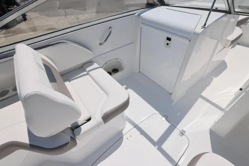 Slide: The Image of 2025 Hurricane SunDeck 235 OB boat interior with white seating and sleek design. - 19