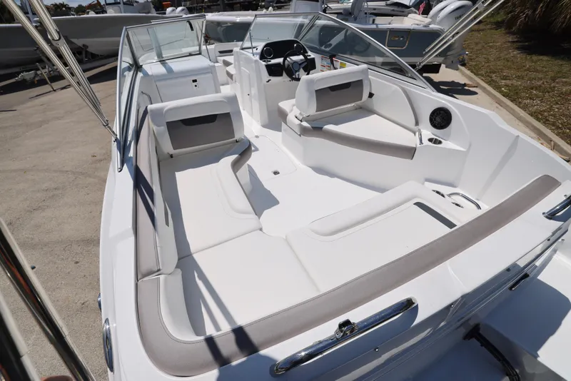 Slide: The Image of 2025 Hurricane SunDeck 235 OB boat with spacious seating and modern design. - 2