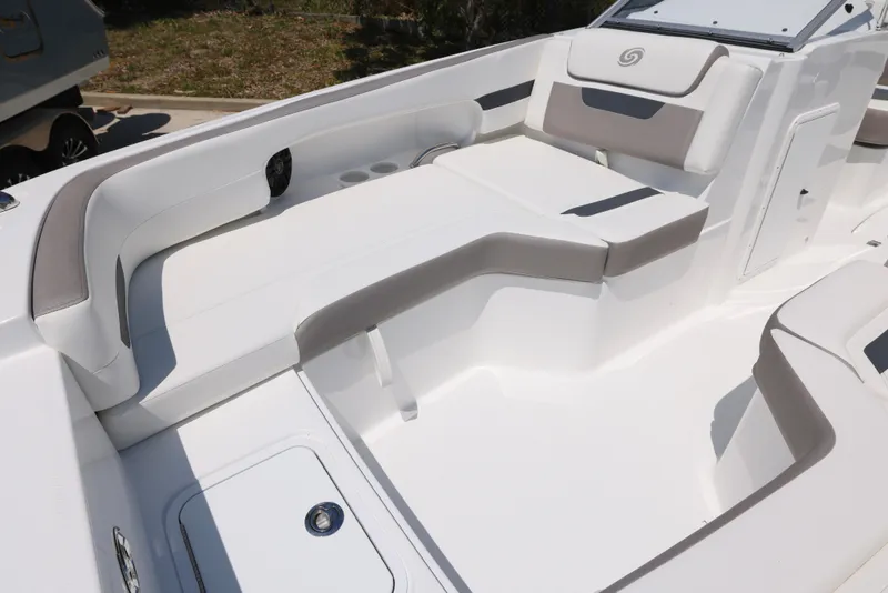 Slide: The Image of 2025 Hurricane SunDeck 235 OB boat interior with white seating and sleek design. - 23