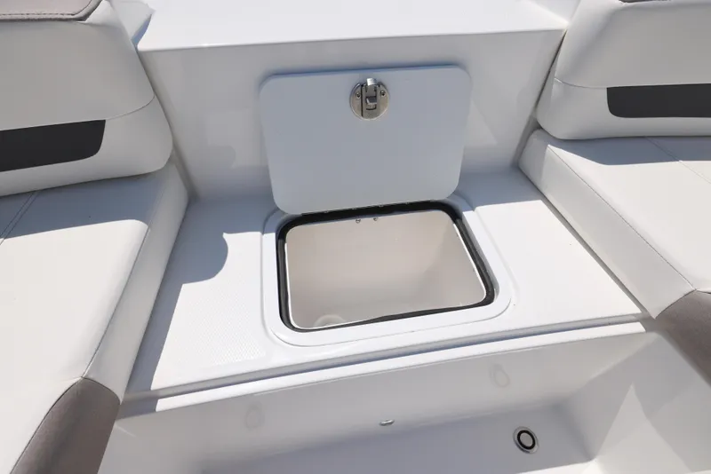 Slide: The Image of 2025 Hurricane SunDeck 235 OB boat storage compartment with open hatch. - 25