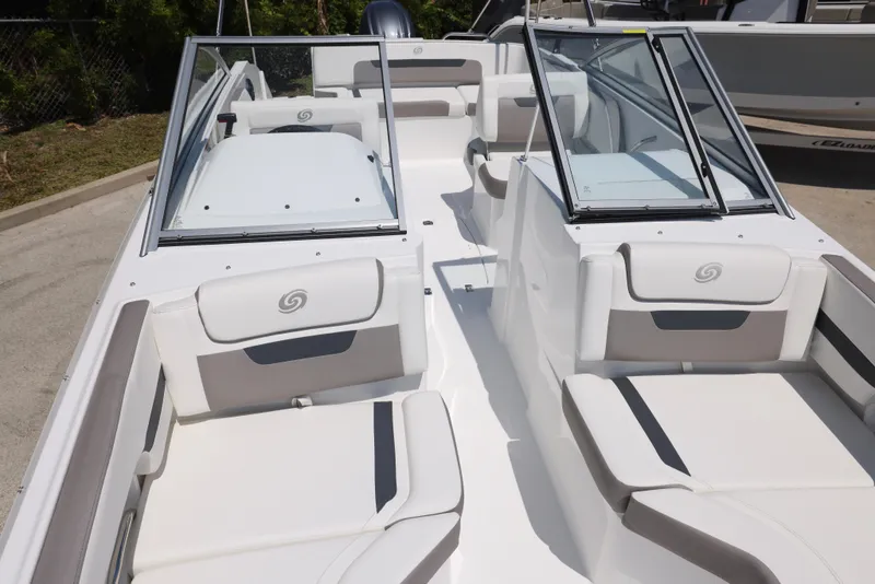 Slide: The Image of 2025 Hurricane SunDeck 235 OB boat interior with white seating and open windshield. - 27