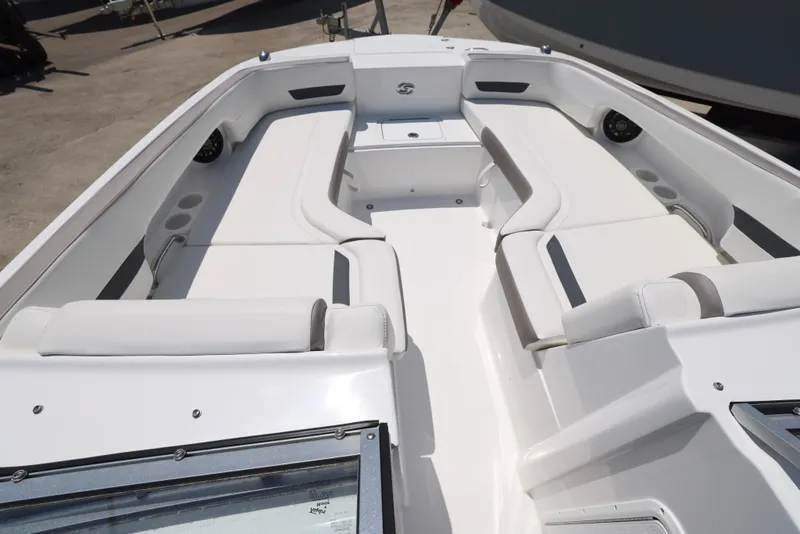 Slide: The Image of 2025 Hurricane SunDeck 235 OB boat interior with white seating and spacious layout. - 3