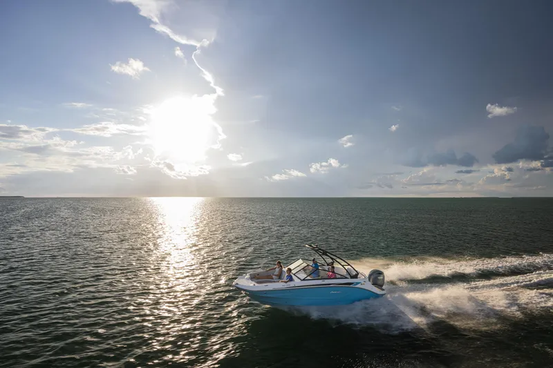 Slide: The Image of 2025 Hurricane SunDeck 235 OB cruising on open water at sunset. - 36