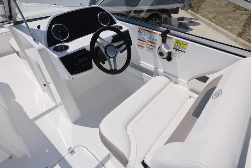 Slide: The Image of 2025 Hurricane SunDeck 235 OB boat interior with steering wheel and seating. - 4