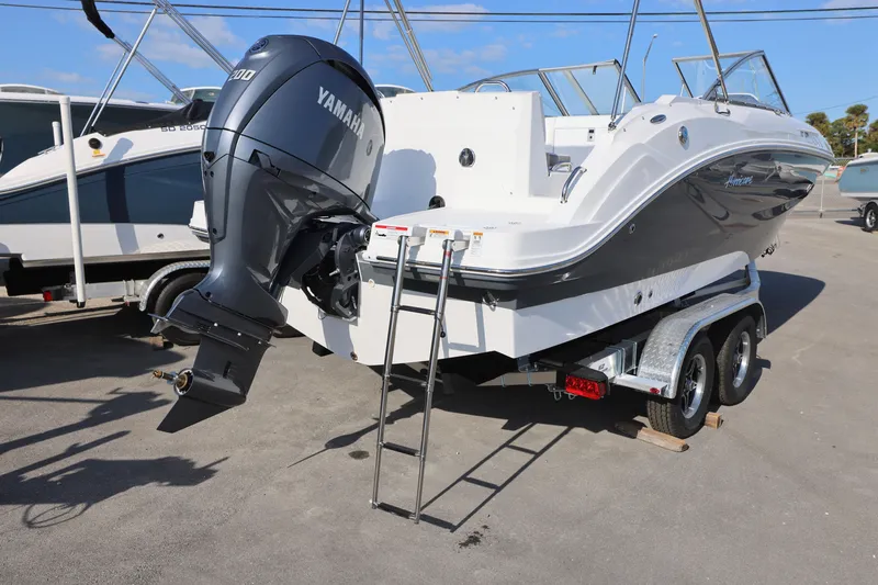 Slide: The Image of 2025 Hurricane SunDeck 235 OB boat with Yamaha outboard motor on a trailer. - 6