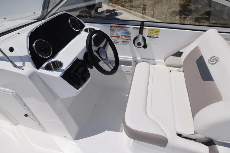 Slide: The Image of 2025 Hurricane SunDeck 235 OB boat interior with steering wheel and seating. - 8