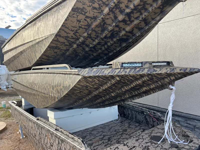 Slide: The Image of 2025 Edge Duck Boats 553 DB with camouflage design, stacked for display. - 2