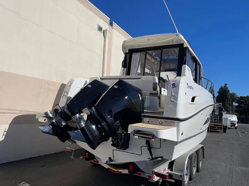 Slide: The Image of 2025 Bayliner Trophy T29 Explorer boat with dual outboard motors on a trailer. - 3