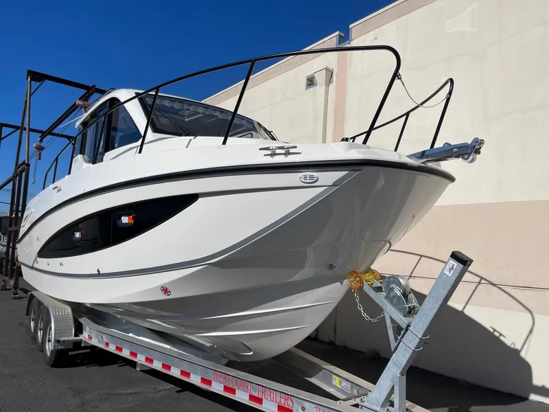 Slide: The Image of 2025 Bayliner Trophy T29 Explorer boat on trailer, sleek design, outdoor display. - 4