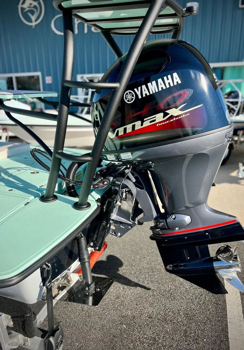 Slide: The Image of 2024 Chittum Skiffs Islamorada 18 with Yamaha outboard motor, showcased outdoors. - 3