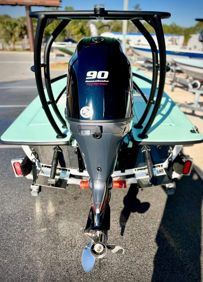 Slide: The Image of 2024 Chittum Skiffs Islamorada 18 with 90 HP outboard motor, rear view. - 4