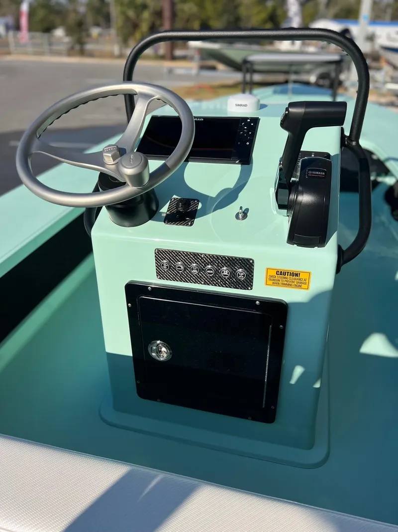 Slide: The Image of 2024 Chittum Skiffs Islamorada 18 boat console with steering wheel and controls. - 6