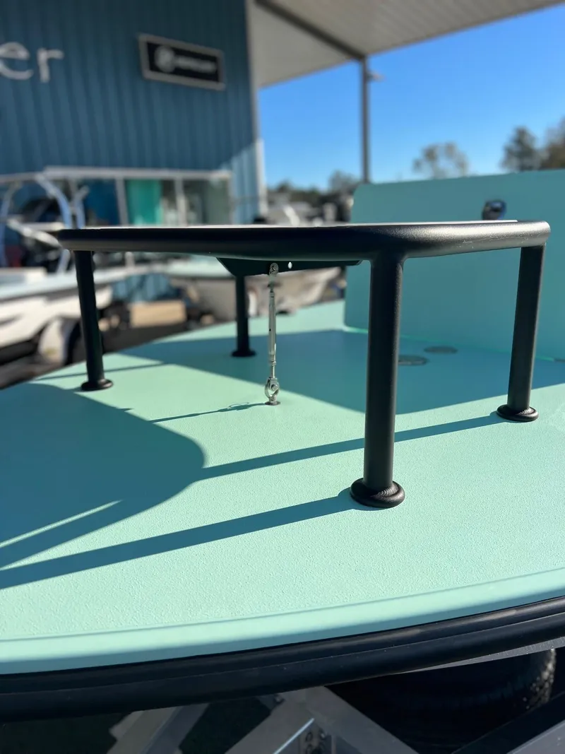 Slide: The Image of 2024 Chittum Skiffs Islamorada 18, mint green deck, under sunny sky. - 8