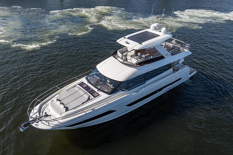 Slide: The Image of Luxury 2021 Prestige 690 yacht cruising on open water. - 11