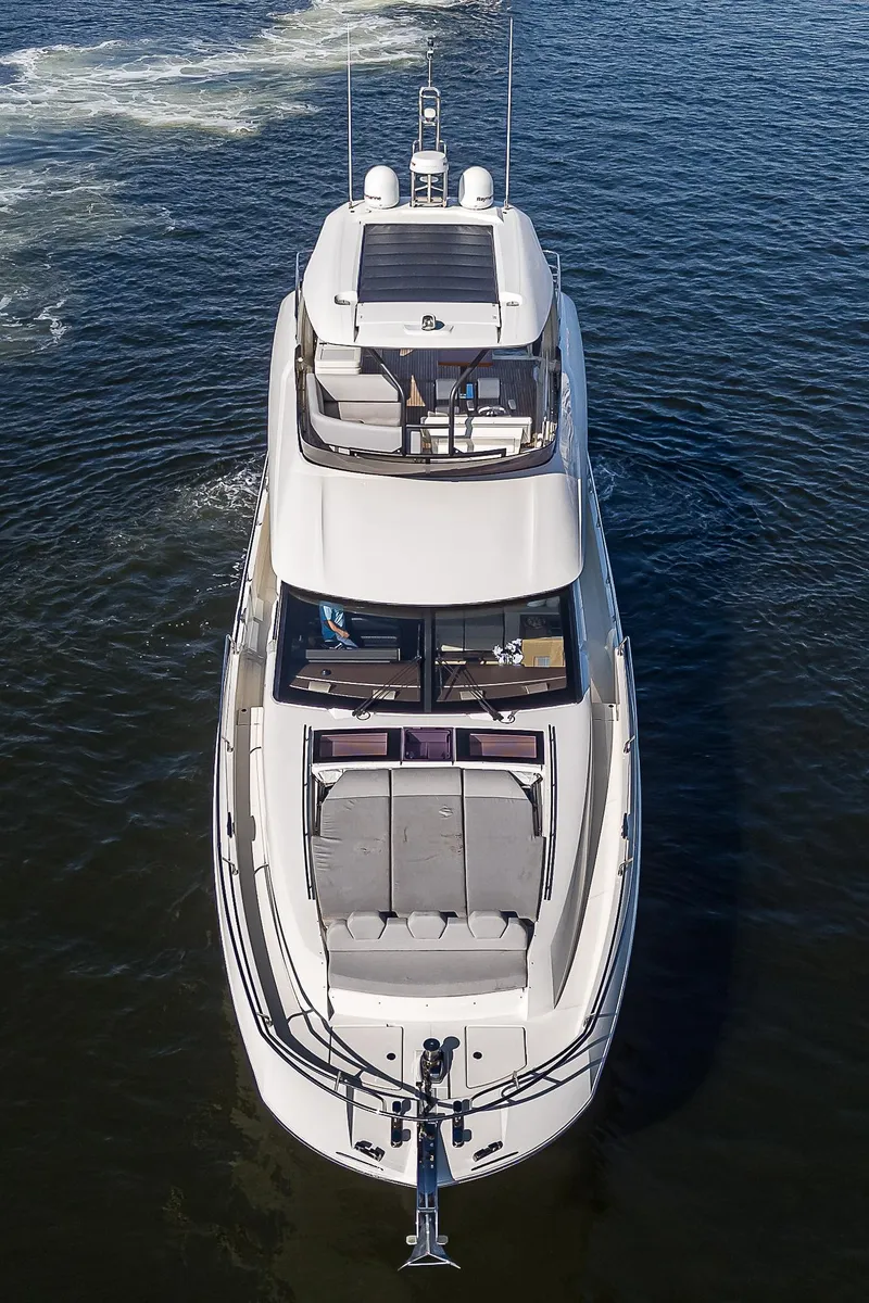 Slide: The Image of Aerial view of 2021 Prestige 690 yacht cruising on open water. - 12