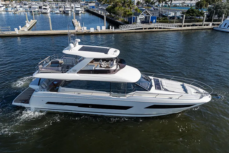 Slide: The Image of Luxurious 2021 Prestige 690 yacht cruising in a marina setting. - 13
