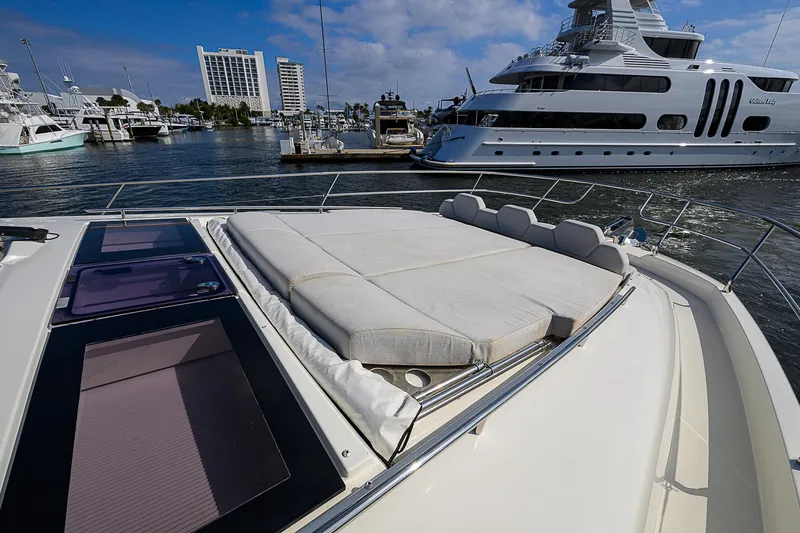 Slide: The Image of Prestige 690 yacht, 2021 model, docked in marina with luxury boats. - 14