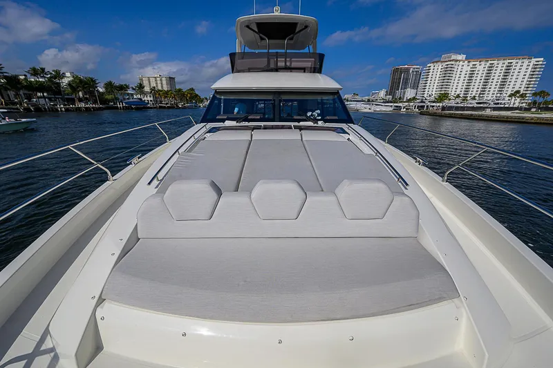 Slide: The Image of Luxury 2021 Prestige 690 yacht with spacious deck, docked in a marina. - 15