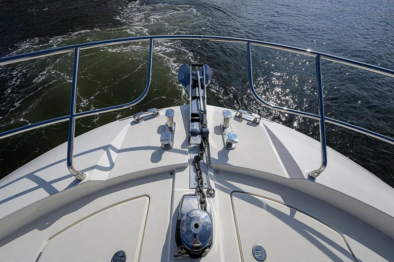 Slide: The Image of Bow view of 2021 Prestige 690 yacht with stainless steel railings on water. - 16