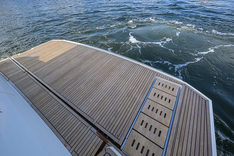 Slide: The Image of Prestige 690 yacht's teak swim platform on water, 2021 model. - 17