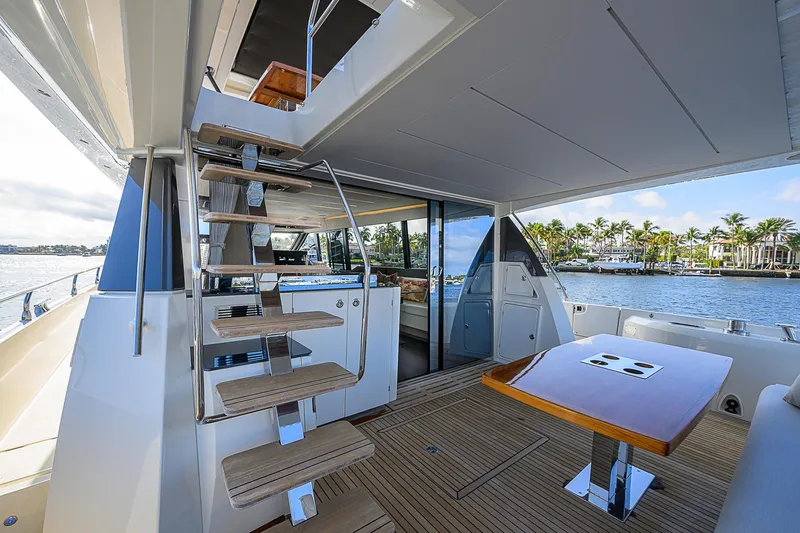 Slide: The Image of Luxurious 2021 Prestige 690 yacht deck with modern staircase and waterfront view. - 21