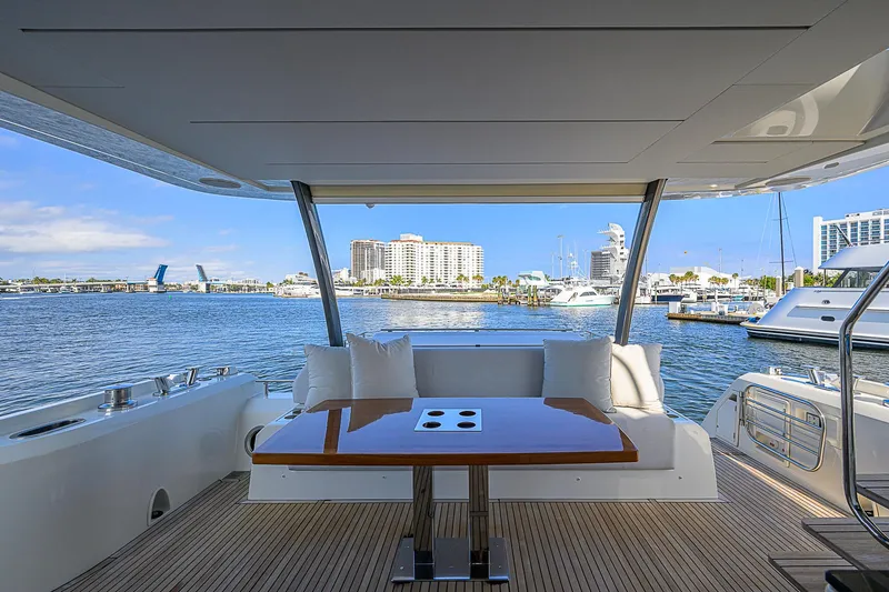 Slide: The Image of Luxurious 2021 Prestige 690 yacht deck with waterfront view and elegant seating area. - 22