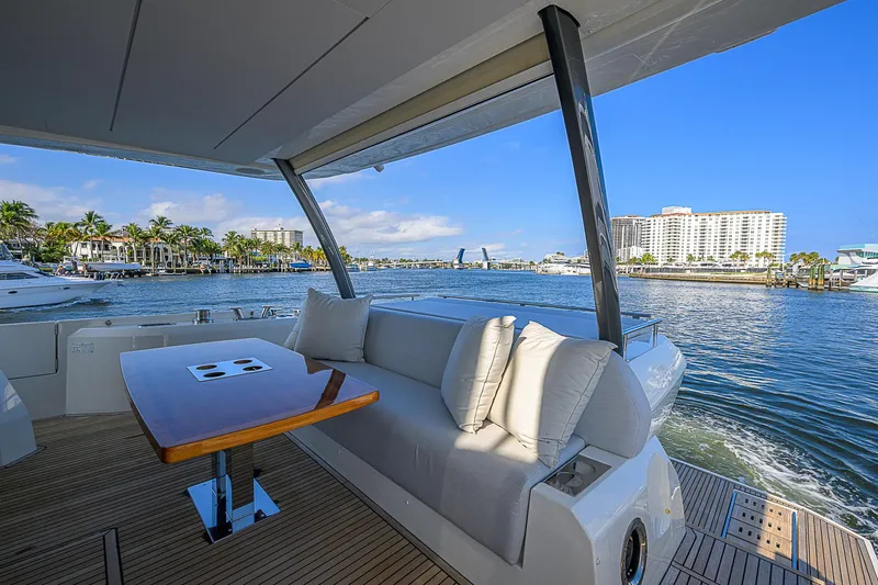 Slide: The Image of Luxurious 2021 Prestige 690 yacht with elegant seating and scenic waterfront view. - 23