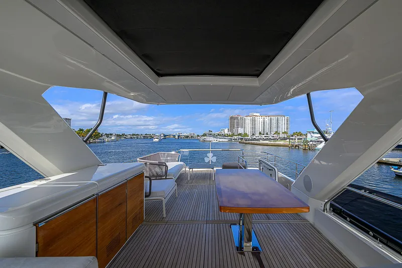Slide: The Image of Luxurious 2021 Prestige 690 yacht interior with waterfront view and elegant seating area. - 33
