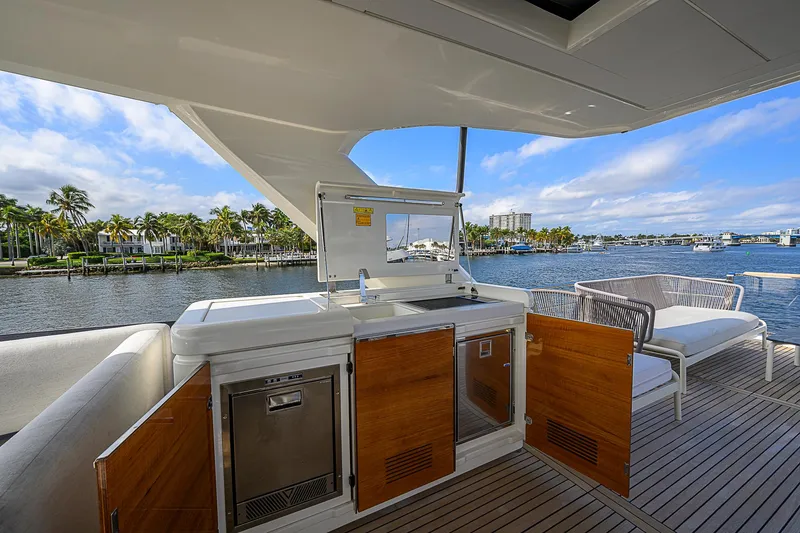 Slide: The Image of Prestige 690 yacht deck with outdoor kitchen and seating, 2021 model. - 34
