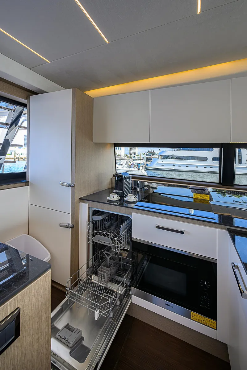 Slide: The Image of Modern kitchen interior on 2021 Prestige 690 yacht with sleek cabinetry and appliances. - 47