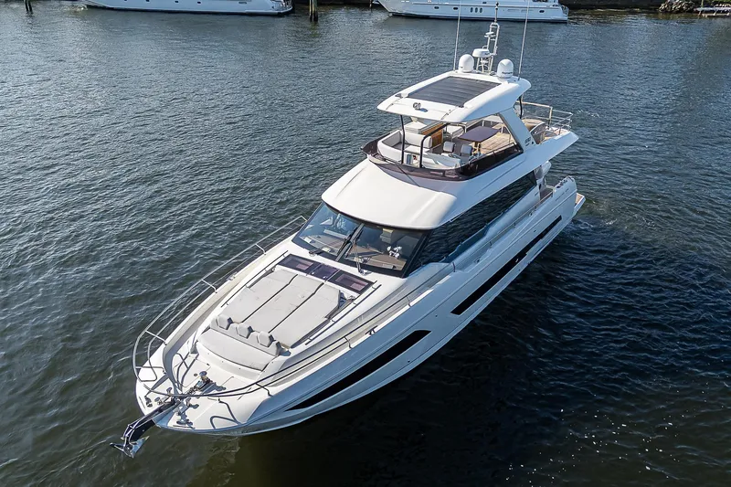 Slide: The Image of Prestige 690 yacht, 2021 model, cruising on calm waters. - 9