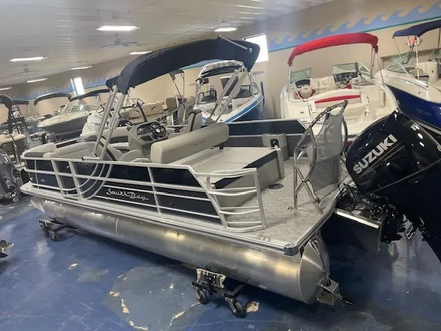 Slide: The Image of 2025 South Bay 200 pontoon boat with Suzuki outboard motor in showroom. - 5