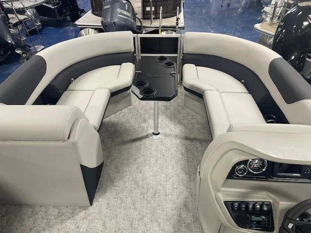 Slide: The Image of 2025 South Bay 200 boat interior with plush seating and central table. - 9