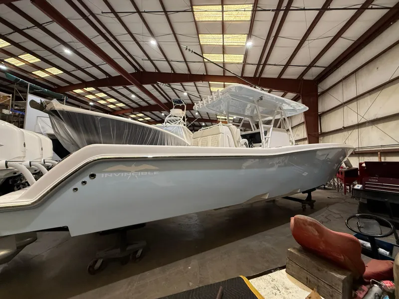 Slide: The Image of 2022 Invincible 39 Open Fisherman boat in a warehouse setting. - 10