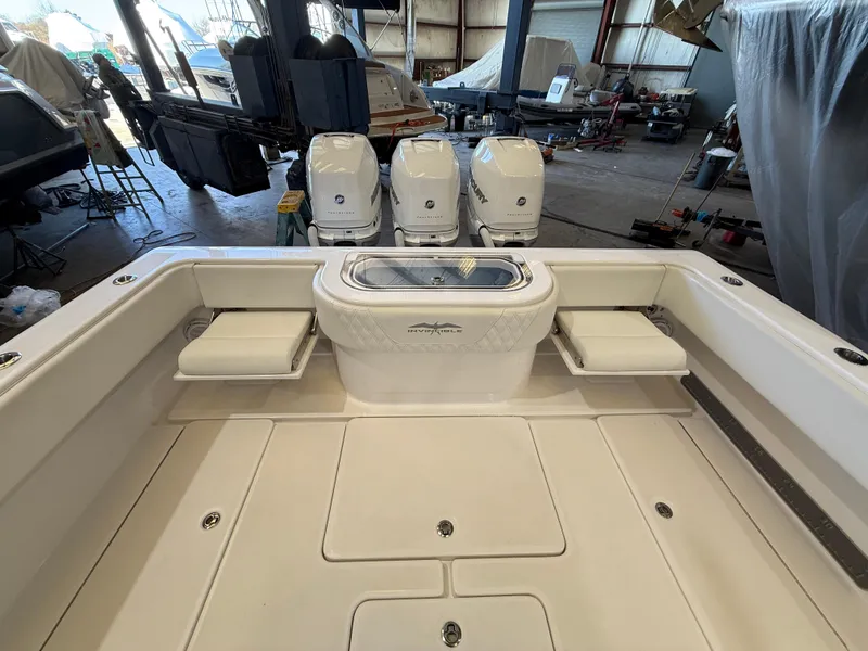 Slide: The Image of 2022 Invincible 39 Open Fisherman boat with triple engines in a storage facility. - 19