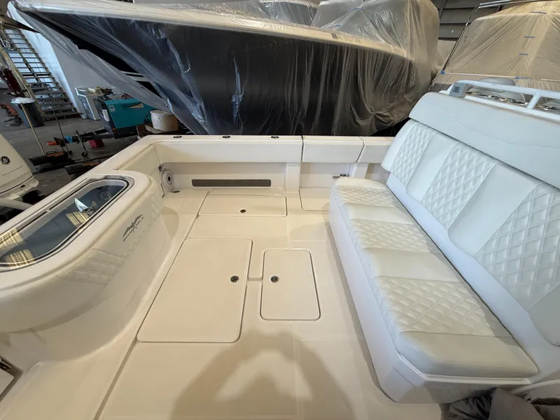 Slide: The Image of 2022 Invincible 39 Open Fisherman boat interior with white seating and storage compartments. - 20