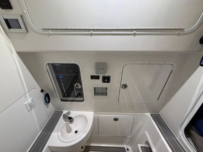 Slide: The Image of 2022 Invincible 39 Open Fisherman interior with sink and control panel. - 29