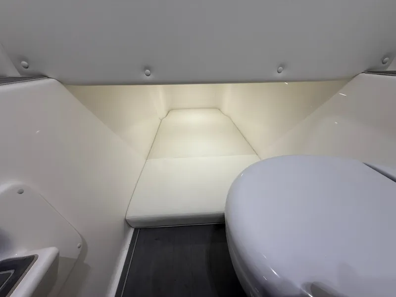 Slide: The Image of Interior cabin of 2022 Invincible 39 Open Fisherman boat, featuring a compact toilet. - 30