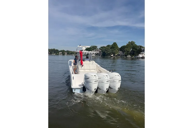 Slide: The Image of 2022 Invincible 39 Open Fisherman boat with triple Mercury engines on a calm lake. - 31