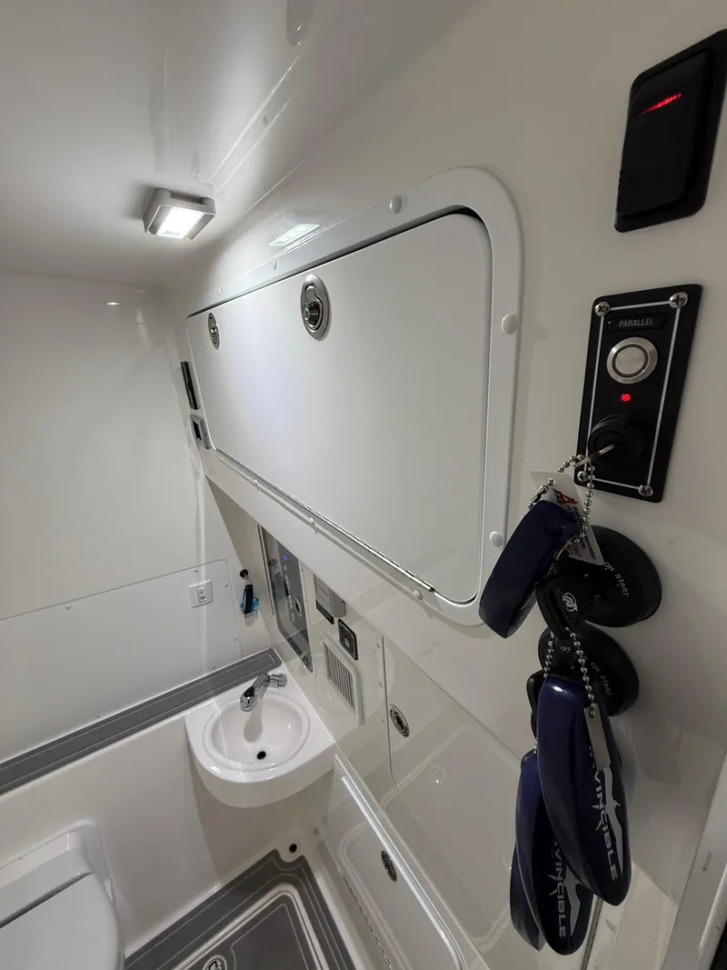 Slide: The Image of 2022 Invincible 39 Open Fisherman interior with sink and storage compartments. - 32